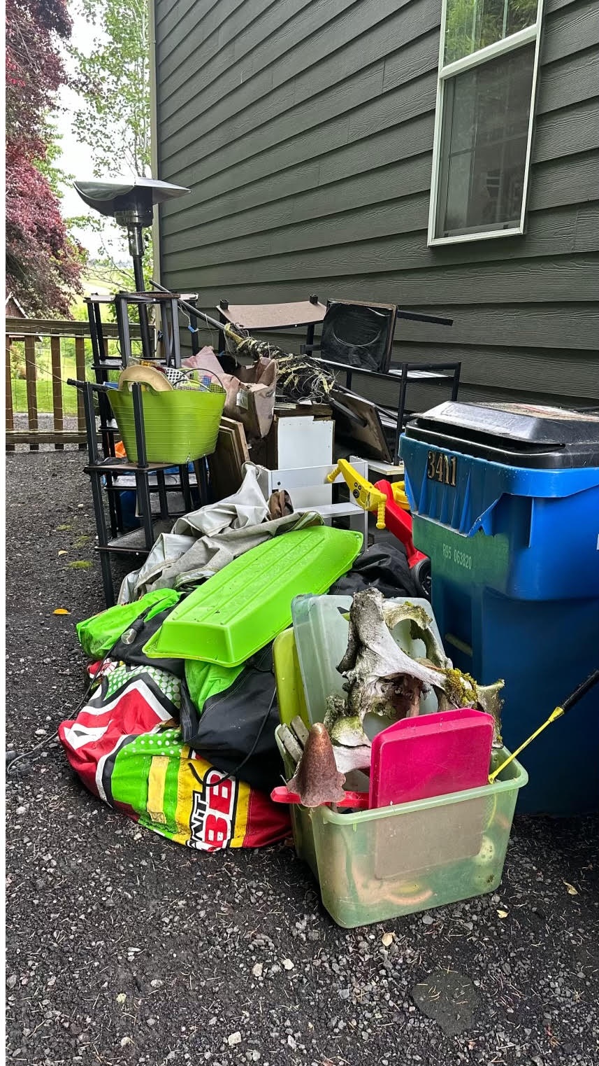 Backyard cluttered with junk before Fellas Services cleanup